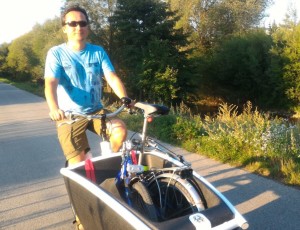 Homme qui transporte un vélo pliant dans un cargobike